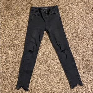 High waisted distressed black skinny jeans.